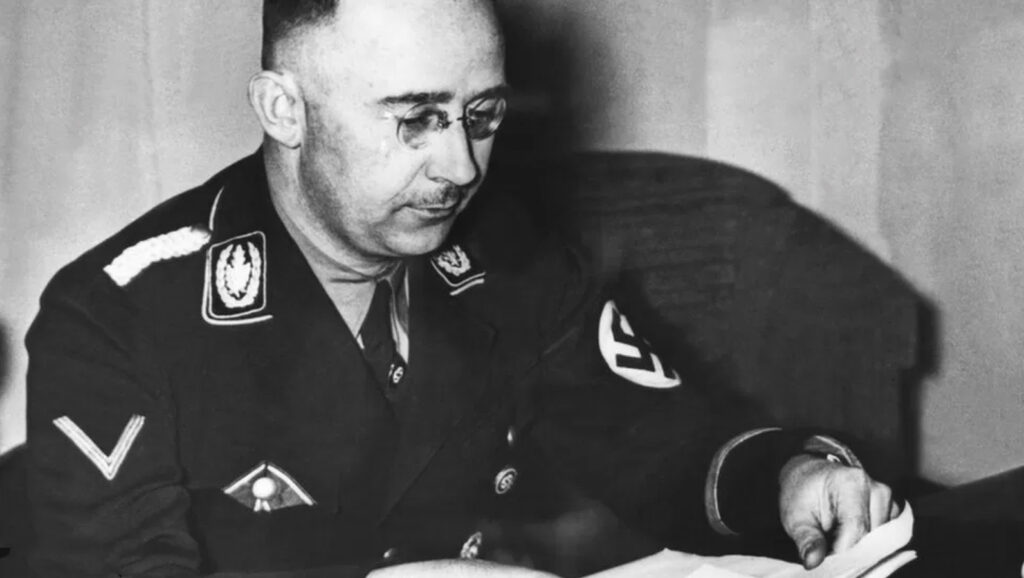 A portrait of a prominent Nazi party leader, dressed in a military uniform, with a stern expression reflecting the authority and ideology of the regime